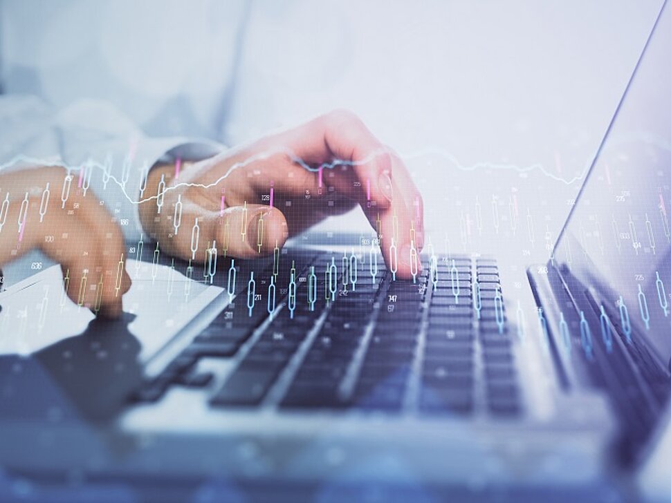Double,Exposure,Of,Market,Chart,With,Man,Working,On,Computer
